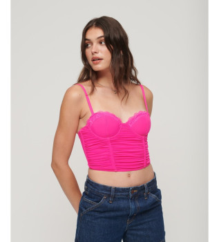 Top corto con corsetto in rete rosa con volant