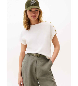 Majica z zlatimi gumbi na ramenu v beli barvi