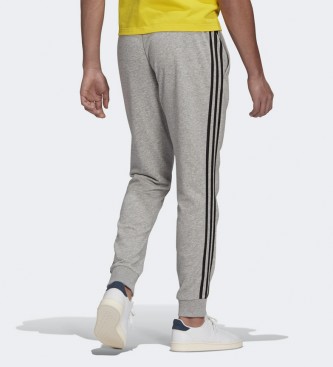 adidas Pantalon Essentials French Terry Tapered Cuff 3-Stripes gris