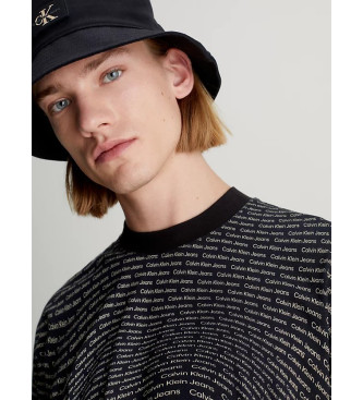 Calvin Klein Jeans Schwarzes, lockeres T-Shirt mit All-Over-Logo