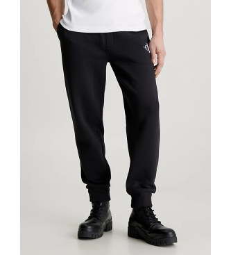 Calvin Klein Jeans Hlače trenirke Bombažne hlače iz flisa Hlače trenirke črne