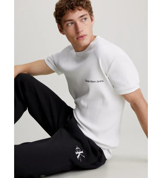 Calvin Klein Jeans Calas de fato de treino Calas de fato de treino de algodo Fleece preto